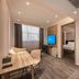 Hanting Hotel Hai'an Renmin West Road in Nantong, guest room with desk, TV, bedroom and glass shower area