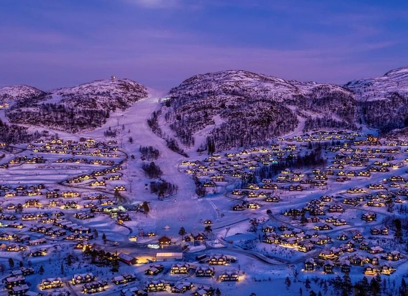 Rauland Høgfjellshotell in Rauland with snowy mountain village lights at dusk
