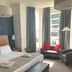 West Rocks Townhouse in Eastbourne guest room with bed, bench, seating area and bay window