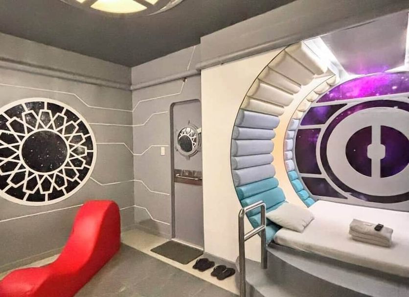 Astrotel Cubao in Quezon City, futuristic themed room with circular bed alcove and bold red chair