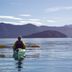 Bay of Many Coves in Picton: person kayaking on calm bay with mountain views