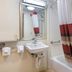 Red Roof Inn Detroit - Farmington Hills bathroom with tub, shower curtain, sink and mirror