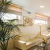 Hotel Orizzonte in Letojanni lounge with cream sofas, glass coffee tables and potted plants