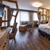 Hotel Interski in Santa Cristina Valgardena guest room with king bed, seating area and mountain mural