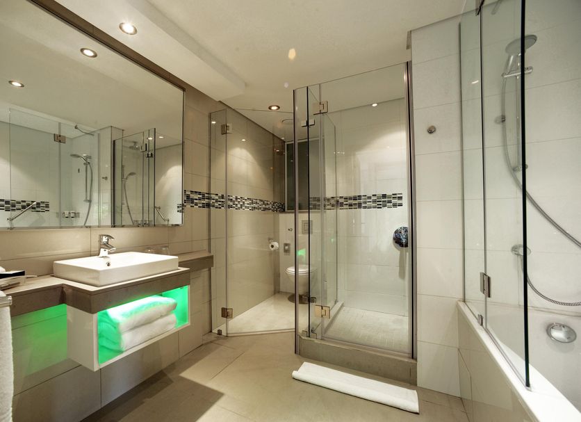 Holiday Inn Mauritius Mon Tresor By IHG bathroom with glass shower, vanity sink and bathtub in Mahébourg