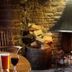 The Anchor Inn, Bristol: cozy stone fireplace with burning fire, wood stack, and rustic seating