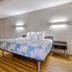 Motel 6 Little Rock, Ar - South room with king bed, wall lights, and wood-look flooring in Little Rock