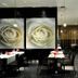 Vila Gale Coimbra restaurant interior with rose wall art, tables, black chairs and lit shelves in Coimbra