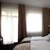 La Petite Apartments & Rooms, Gdansk: bright guest room with twin beds and large windows with curtains