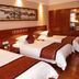 Sanqingshan Jinshawan Holiday Hotel Shangrao guest room with three twin beds and wall art