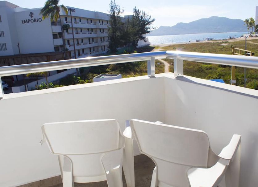 Venados Inn in Mazatlán balcony with two white chairs and view of the bay and mountains