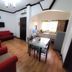 Sunny Point Hotel, Davao City: simple suite with red sofas, dining table, TV, and compact kitchenette