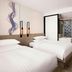 Fairfield by Marriott Busan room with two beds, wood flooring, and bathroom visible in Busan