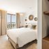 Le Mirage in Bormes-les-Mimosas bedroom with balcony doors, sea view and built-in shelves