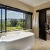 Shepherd's Tree Game Lodge in Pilanesberg bathroom with freestanding tub and large window overlooking landscape