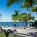 The Capitana Key West beach with lounge chairs, palm trees and ocean view in Key West