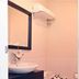 Home Edge Accommodations @ Tivoli Garden Residences Manila bathroom with sink, mirror, toilet, and wall shelf