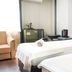 Hotel Guleryuz Antalya guest room with two single beds, armchair, and mini fridge