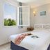 Terres de France - Résidence de la Cabre d'Or bedroom with open window and double bed in Cabriès