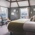 Chainlocker, Falmouth guest room with double bed, tall windows and harbor view