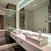 Hotel Cercano Gramado bathroom with double sinks, glass shower and soaking tub
