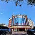 Wuyue Yuexin Hotel (Jinggangshan) in Ji'an, curved glass-front hotel exterior under blue sky