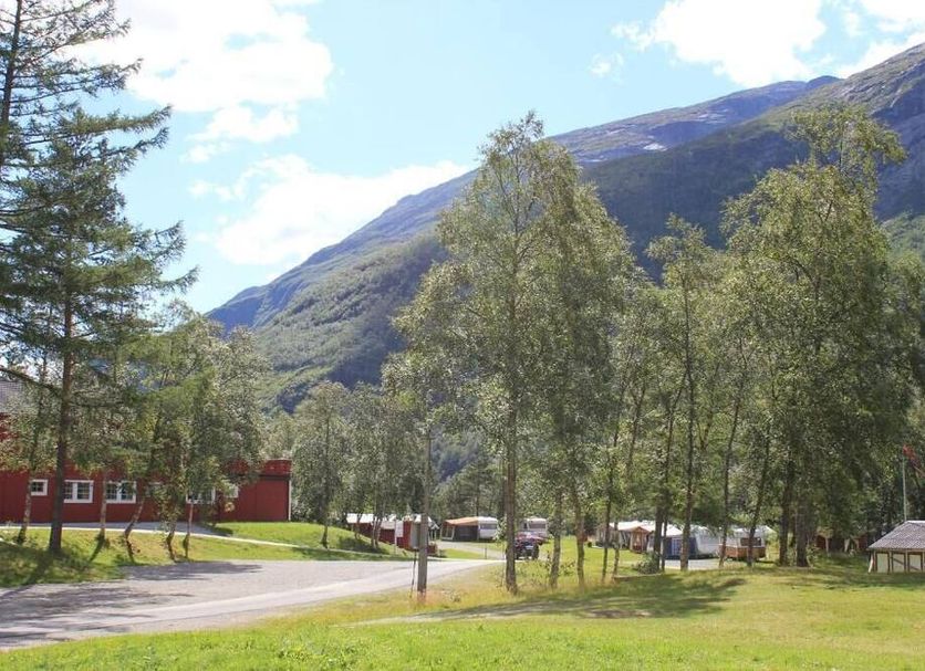 Trædal Hotel in Sunndalsøra with mountain views, trees, a grassy lawn and nearby road