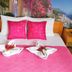 Apartments Villa Kukoljac in Herceg Novi with pink bed decor and coastal mural backdrop