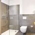 Haus Dumicketal in Drolshagen bathroom with glass shower, wall-mounted toilet and vessel sink