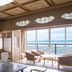 Hotel Biwanso in Nanao: traditional room with tatami seating and large ocean-view windows