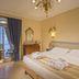 Abano Ritz Hotel Terme in Abano Terme bedroom with balcony view, chandelier and twin bed