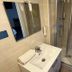 Contact Hôtel les Platanes Villeneuve sur Lot Centre bathroom with sink, mirror and glass shower