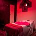 Le Pearl Goa Resort & Spa in Vagator, red-lit spa treatment room with massage table