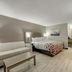 Red Roof Inn Kingsport room with sofa, bed, floor lamp and wood-style flooring