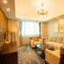 Jinshan Hotel Shanghai living room suite with sofa, armchairs, coffee table and window view