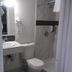 Essex Motel, Alturas: compact bathroom with toilet, sink, and walk-in shower
