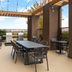 Home2 Suites by Hilton Alexandria rooftop terrace with dining tables, chairs and city views