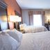 Hampton Inn By Hilton Elliot Lake guest room with two beds, TV, chair and window seating