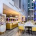 Atrium Hotel Heathrow in Hounslow dining area with yellow chairs and buffet tables