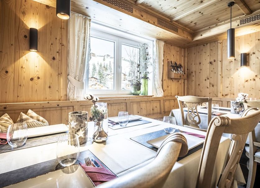 Anthonys Alpin Hotel in Lech am Arlberg dining room with wood-paneled walls and snowy window view