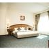 Cherry Maryski Hotel, Alexandria: bright guest room with king bed, window drapes, and seating area