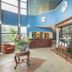 Baymont by Wyndham Laurel lobby with front desk, tall windows, and glass display case in Laurel