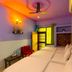 Anukampa Paying Guest House, Agra: colorful twin room with two beds, fan, and window light