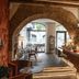 Petit Hôtel Confidentiel in Chambéry: arched stone interior with bar, seating, and dining area