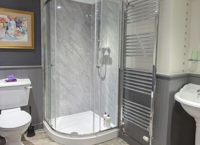 Court Prior Boutique B&B and Apartment bathroom with corner shower, toilet and heated towel rail in Torquay