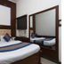 Vishal Hotel Near New Delhi Railway Station room with king bed, wall mirror, and window AC in New Delhi