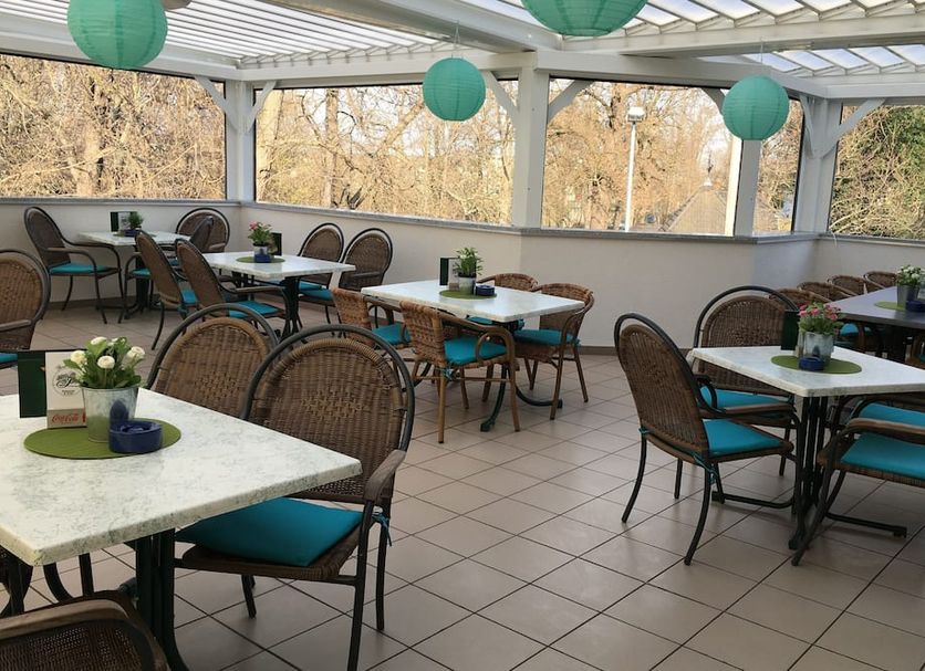 Hotel & Restaurant Park Cafe Isa in Erfurt outdoor terrace dining area with tables and wicker chairs