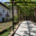 Hotel Gentile in Agerola garden walkway under vine-covered pergola with sunny path