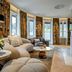 Hotel Bareiss in Baiersbronn lounge with curved sofa, marble fireplace, and bay windows overlooking greenery