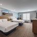 Ayres Hotel & Spa Moreno Valley/Riverside room with two queen beds, wall art, TV and window in Moreno Valley